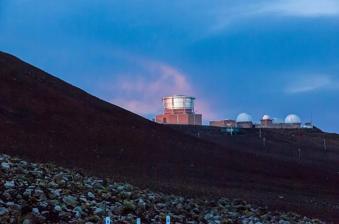 Observatory domes on the Haleakala summit in the blue light before dawn